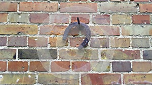 Horseshoe hanging on a brick wall