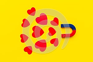 Horseshoe magnet attractives heart shapes. Love and relashionship concept