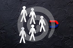 Horseshoe magnet attractives human figures. Increase team and recruiting concept photo