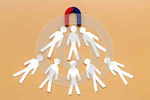 Horseshoe magnet attractives human figures. Increase team and recruiting concept photo