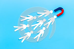Horseshoe magnet attractives human figures. Increase team and recruiting concept photo