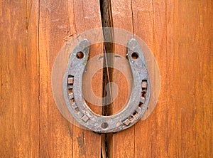 Horseshoe on a wooden crack. The concept of good luck and safety. Protect from destruction, failures and misfortunes.