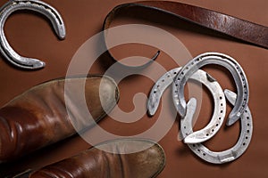 Horseshoes, belt and a pair of leather shoes