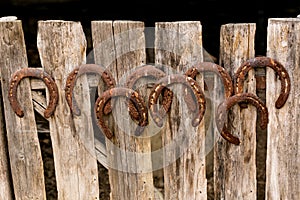 Horseshoes on an old wooden fence