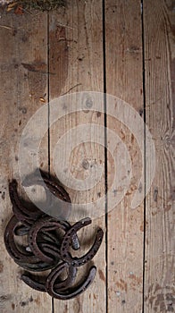 Horseshoes wallpaper on a worn wooden surface