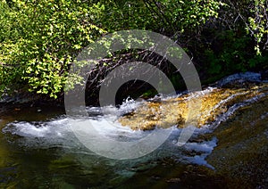 Horsetail Falls cascade down the cliffs in Lone Peak Wilderness along the Wasatch Front Rocky Mountains, Alpine Utah. photo