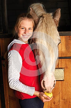 Horsewoman with his horse in the stable. Sport