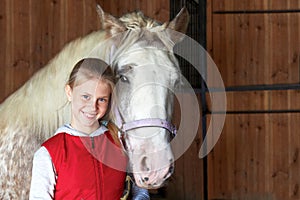 Horsewoman with his horse in the stable. Sport