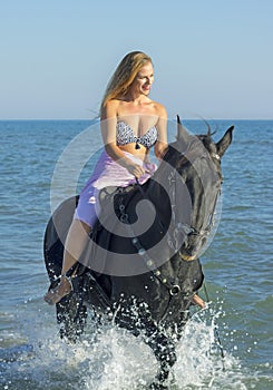 Horsewoman and horse in the sea