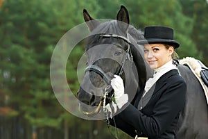 Horsewoman jockey in uniform with horse