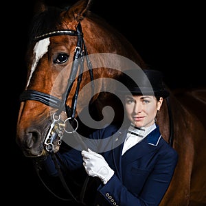 Horsewoman in uniform with a brown horse