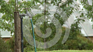 Hose Connected To Outdoor Spigot
