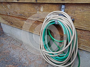 Hose Reel Against Cedar Siding