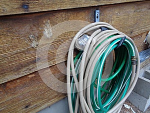 Hose Reel Against Cedar Siding Wall