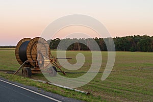 A hose reel - sprinkler system on a field