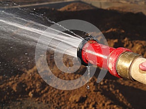 Hose Spraying Water on Ground - Horizontal