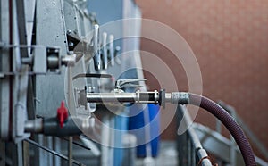 Hose and valve leading from wine storage tank at Maxwell Wines, McLaren Vale, South Australia