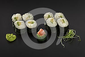 Hosomaki sushi rolls with avocado decorated with wasabi photo