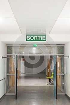 Hospiral corridor with Exit panel writing in french : Sortie, traduction in english of exit