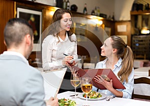 Hospitable waitress taking order photo