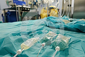 A hospital bed filled with a variety of medical devices and equipment, ready for patient care, Catheters and IV bags in a sterile