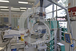 Hospital bed trapeze, on background patient  connected to medical ventilator in ICU in hospital, a place where can be treated