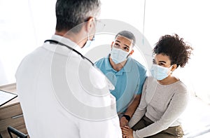 Hospital conversation, couple and doctor consulting on medical consultation, gynecology news or wellness health support