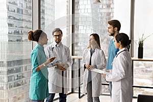 Hospital diverse staff of young practitioners standing in office hall