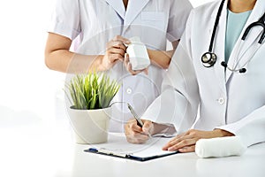 Hospital and Healthcare staff, Professional medical care provider, Doctor writing note for treatment.