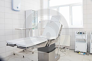 Hospital interior design with operating table and lamp with cabinets and modern devices in light surgery room.modern