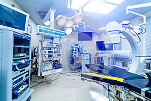 Hospital interior with operating surgery table, lamps and ultra modern devices, technology in modern clinic