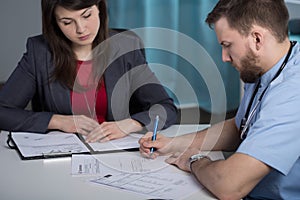 Hospital manager talking with medic