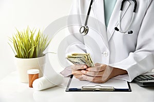 Hospital and medical expense, Doctor holding banknote money.