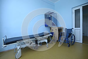 Hospital phoning room for patients: phone, wheelchair and stretcher