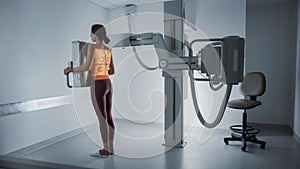 Hospital Radiology Room: Beautiful Multiethnic Woman Standing Topless in the X-Ray Machine. Adult