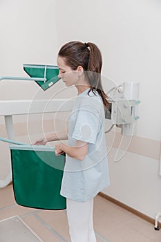 Hospital Radiology Room. Xray machine for fluorography. Woman patient scanning chest, heart or lungs in clinic office