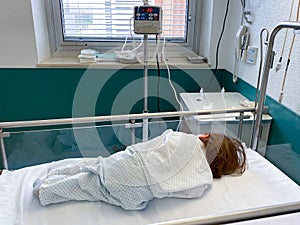 Hospital room with an unrecognizable baby girl in a crib
