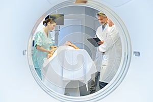 Hospital scene viewed through round window in door