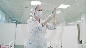 Hospital unit with a doctor filling a syringe before vaccination