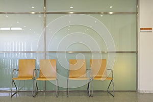 Hospital waiting area with metallic chairs.