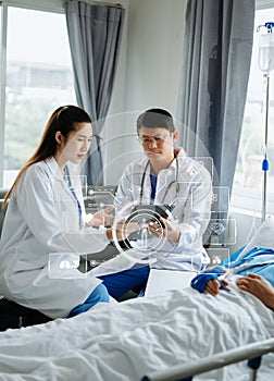 Hospital Ward Male and Female Professional Caucasian Doctors Talk with a Patient, Give Health Care Advice, Recommend Treatment