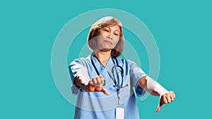 Hospital worker showing thumbs down sign