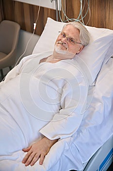 Hospitalized mature male lying in hospital ward