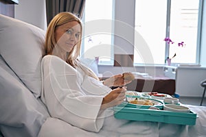 Hospitalized patient having lunch in private clinic ward