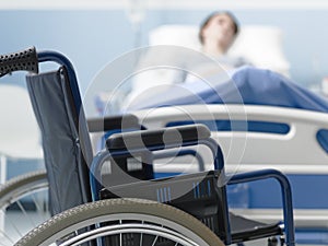 Hospitalized patient lying in bed and wheelchair