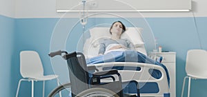 Hospitalized patient lying in bed and wheelchair