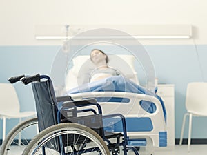 Hospitalized patient lying in bed and wheelchair