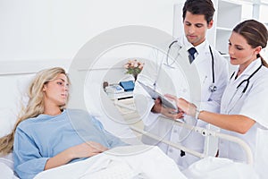 Hospitalized woman and doctors