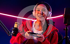 Host channel smiling Asian with joystick playing online game. Stratagem.