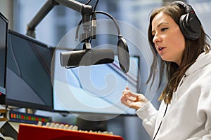 Host Talking On Microphone In Radio Studio